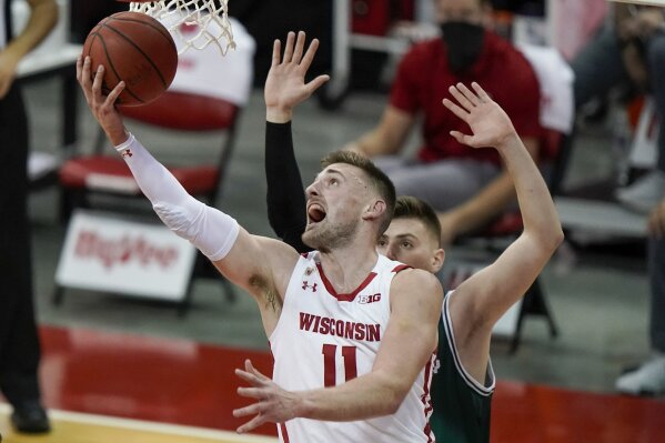 Wisconsin's Micah Potter shoots past Wisconsin-Green Bay's Cem Kirciman during the second half of an NCAA college basketball game Tuesday, Dec. 1, 2020, in Madison, Wis. (AP Photo/Morry Gash)
