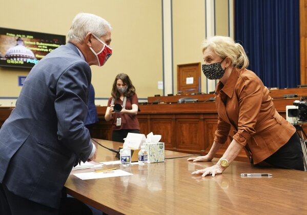 Dr. Anthony Fauci, director of the National Institute for Allergy and Infectious Diseases, speaks with Rep. Carolyn Maloney, D-N.Y., right, after a House Subcommittee on the Coronavirus crisis hearing, Friday, July 31, 2020 on Capitol Hill in Washington. (Kevin Dietsch/Pool via AP)