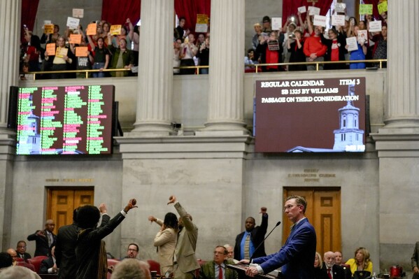 Rep. Ryan Williams, R-Cookeville, right, watches his bill to allow some teachers to be armed in schools pass the House as others react during a legislative session Tuesday, April 23, 2024, in Nashville, Tenn. (AP Photo/George Walker IV)