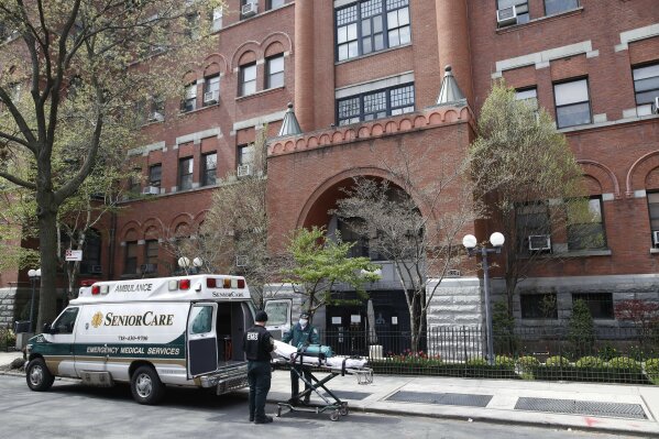 Emergency medical workers arrive at Cobble Hill Health Center, Friday, April 17, 2020, in the Brooklyn borough of New York. The despair wrought on nursing homes by the coronavirus was laid bare Friday in a state survey identifying numerous New York facilities where multiple patients have died. (AP Photo/John Minchillo)