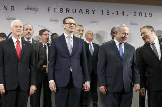 FILE - In this Thursday, Feb. 14, 2019 file photo, United States Vice President Mike Pence, Prime Minister of Poland Mateusz Morawiecki, Israeli Prime Minister Benjamin Netanyahu and United State Secretary of State Mike Pompeo, from left, stand on a podium at a conference on Peace and Security in the Middle East in Warsaw, Poland. A two-day security conference in Warsaw was supposed to be a crowning achievement for Israeli Prime Minister Benjamin Netanyahu, stamping a seal on his long-held goal of pushing his behind-the-scenes ties with Arab leaders into the open. Instead, the publicity-seeking Israeli leader made one embarrassing misstep after another, distracting attention from his main mission and sending his aides into a nonstop cycle of damage control. (AP Photo/Michael Sohn, File)