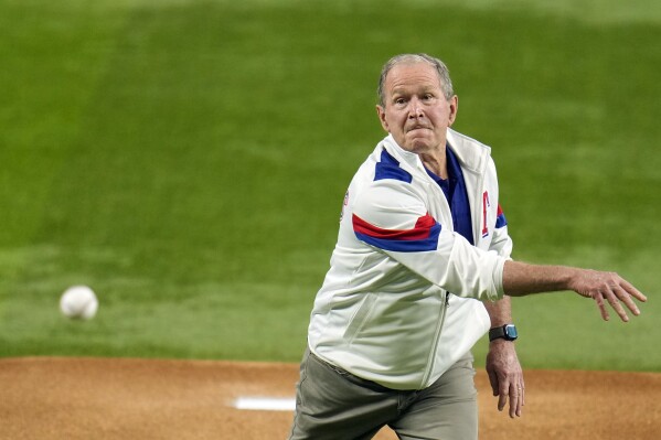 Former Preisdent George W. Bush throws out the ceremonial first pitch before Game 1 of the baseball World Series between the Arizona Diamondbacks and Texas Rangers Friday, Oct. 27, 2023, in Arlington, Texas. (AP Photo/Julio Cortez)