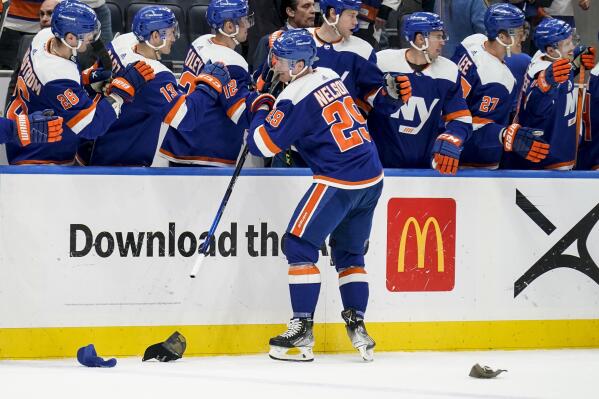 New York Islanders center Brock Nelson (29) celebrates at the bench after scoring a hat-trick goal in the third period of an NHL hockey game against the Dallas Stars, Saturday, March 19, 2022, in Elmont, N.Y. (AP Photo/John Minchillo)
