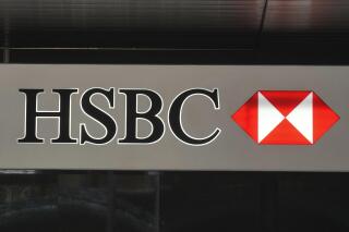 FILE - The logo of the HSBC is seen on a building in Hong Kong, Nov. 16, 2021. Banking giant HSBC announced Wednesday, Dec. 14, 2022, it will no longer finance new oil and gas fields as part of its updated climate strategy. (AP Photo/Vincent Yu, File)