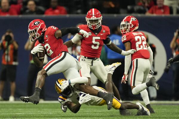 Georgia linebacker Smael Mondon Jr. (2) tries to escape from LSU wide receiver Brian Thomas Jr. (11) after intercepting a pass in the first half of the Southeastern Conference Championship football game Saturday, Dec. 3, 2022 in Atlanta. (AP Photo/John Bazemore)