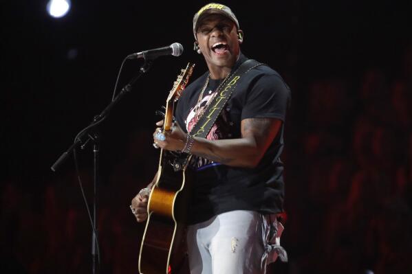FILE - Jimmie Allen performs "Best Shot" at the CMT Music Awards in Nashville, Tenn. on June 5, 2019. Allen will be introduced today as singer of the national anthem prior to the May 30 Indianapolis 500 at Indianapolis Motor Speedway.  (AP Photo/Mark Humphrey, File)