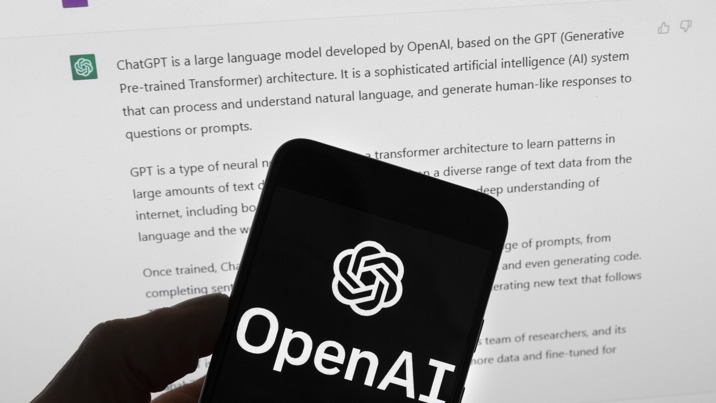 FILE - The OpenAI logo is seen on a mobile phone in front of a computer screen which displays output from ChatGPT, March 21, 2023, in Boston. A wave o