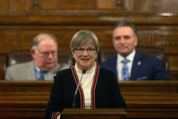 FILE - Kansas Gov. Laura Kelly delivers her State of the State address, Jan. 10, 2024, at the Statehouse in Topeka, Kan. On Friday, Jan. 26, Kelly fulfilled her pledge to veto a broad package of tax cuts approved by the Republican-led Legislature, saying the income tax changes would overwhelmingly favor the wealthy. (Evert Nelson/The Topeka Capital-Journal via AP, File)