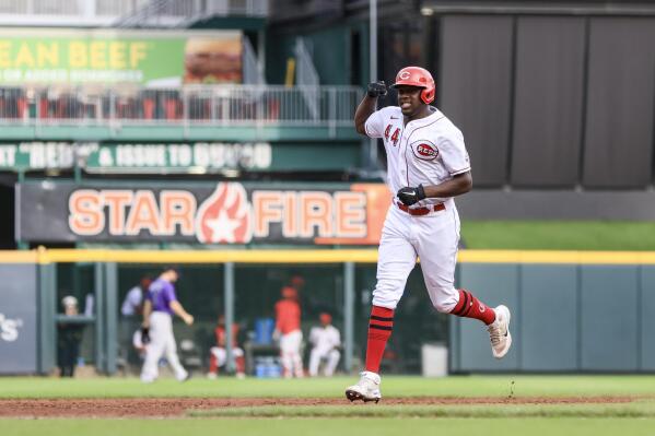Cincinnati Reds' Aristides Aquino flexes as he runs the bases after hitting a grand slam during the sixth inning of the second game of a baseball doubleheader against the Colorado Rockies in Cincinnati, Sunday, Sept. 4, 2022. (AP Photo/Aaron Doster)