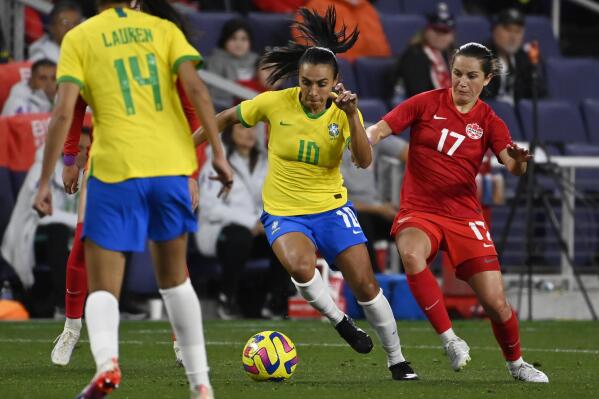Brazil forward Marta (10) moves the ball past Canada midfielder Jessie Fleming (17) during the second half of a SheBelieves Cup soccer match Sunday, Feb. 19, 2023, in Nashville, Tenn. Canada won 2-0.(AP Photo/Mark Zaleski)