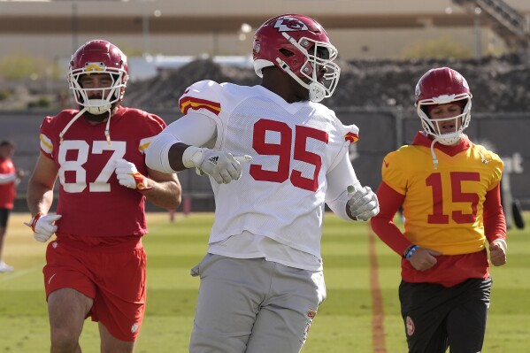 Kansas City Chiefs tight end Travis Kelce (87), defensive tackle Chris Jones (95) and quarterback Patrick Mahomes (15) run during practice for Super Bowl 58 Thursday, Feb. 8, 2024 in Henderson, Nev. (AP Photo/Charlie Riedel)