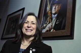 FILE - Marilynn "Lynn" Malerba stands next to a photograph of late Chief Ralph Sturges at Tribal offices in Uncasville, Conn., on March 4, 2010. Malerba, who is Native American, was nominated to be U.S. Treasurer in a historic first, Tuesday, June 21, 2022. Biden's nomination of Malerba to the federal Treasury role was announced ahead of Treasury Secretary Janet Yellen’s visit to the Rosebud Indian Reservation in South Dakota, Tuesday.  (AP Photo/Jessica Hill, File)