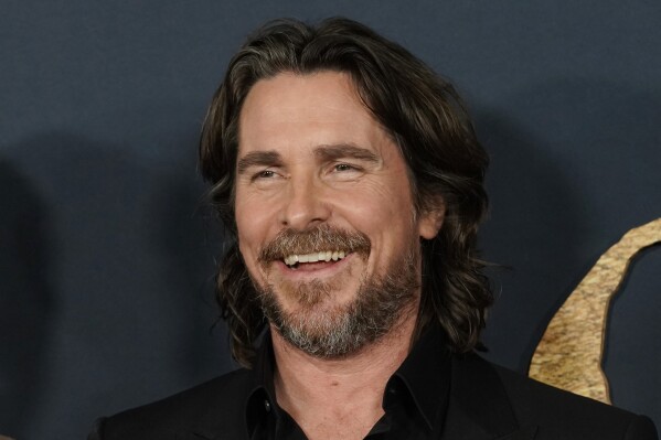 FILE - Christian Bale and cast members in "The Pale Blue Eye," share a laugh at the premiere of the film, Wednesday, Dec. 14, 2022, at the Directors Guild of America in Los Angeles. Bale has broken ground Wednesday, Feb. 7, 2024, on a project he’s been pursuing for 16 years -- the building of a dozen homes and a community center intended to keep siblings in foster care together. (AP Photo/Chris Pizzello, File)