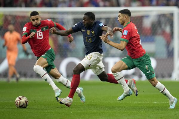 France's Youssouf Fofana, center, vies for the ball with Morocco's Youssef En-Nesyri and Achraf Hakimi, right, during the World Cup semifinal soccer match between France and Morocco at the Al Bayt Stadium in Al Khor, Qatar, Wednesday, Dec. 14, 2022. (AP Photo/Christophe Ena)