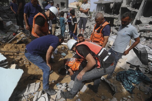 Palestinians search for survivors after an Israeli airstrike on a residential building in Nuseirat Refugee Camp, Gaza Strip, Sunday, May 19, 2024. (AP Photo/Ismael Abu Dayyah)