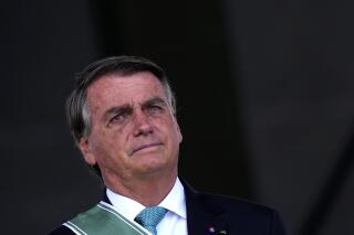 FILE - Brazil's President Jair Bolsonaro attends a ceremony marking Army Day at Army headquarters in Brasilia, Brazil, April 19, 2022. Bolsonaro signed a decree Tuesday, May 24, 2022 that creates stricter rules against environmental crimes in the Amazon rainforest, such as fraud in timber licensing. (AP Photo/Eraldo Peres, File)