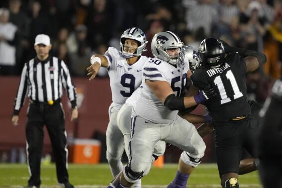 Kansas State offensive lineman Cooper Beebe (50), center, blocks Iowa State defensive lineman Tyler Onyedim (11) as Kansas State quarterback Adrian Martinez (9) passes the ball during the first half of an NCAA college football game, Saturday, Oct. 8, 2022, in Ames, Iowa. (Matthew Putney)