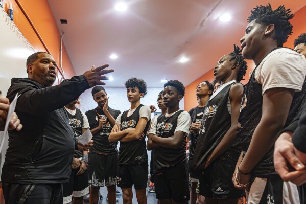 Book Richardson, director of the New York Gauchos boy's basketball program, speaks with his players in the locker room at the Gaucho Gym, Monday, March 11, 2024, in the Bronx borough of New York. (AP Photo/Peter K. Afriyie)