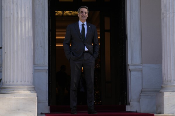 FILE - Greece's Prime Minister Kyriakos Mitsotakis talks to the photographers as he waits for his Bulgarian counterpart Nikolai Denkov at Maximos Mansion in Athens, Thursday, Jan. 4, 2024. Greece's center-right government will soon submit a draft law allowing same-sex civil marriages, despite reservations from its own lawmakers and the country's powerful church, Prime Minister Kyriakos Mitsotakis said Wednesday, Jan. 10. (AP Photo/Thanassis Stavrakis, File)