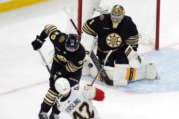 Florida Panthers' Gustav Forsling (42) scores the go-ahead goal against Boston Bruins' Jeremy Swayman (1) as Bruins' Parker Wotherspoon (29) defends during the third period in Game 6 of an NHL hockey Stanley Cup second-round playoff series, Friday, May 17, 2024, in Boston. (AP Photo/Michael Dwyer)