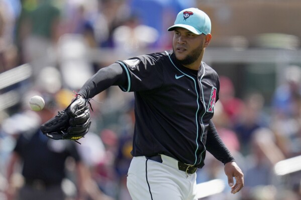 Arizona Diamondbacks starting pitcher Eduardo Rodriguez gets the ball back during the first inning of a spring training baseball game against the Milwaukee Brewers, Sunday, March 3, 2024, in Scottsdale, Ariz. (AP Photo/Ross D. Franklin)