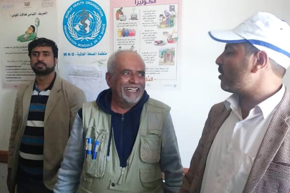 This undated photo provided by Ishaq Abdel-Wareth shows Dr. Yassin Abdel-Wareth, center, one of a handful of epidemiologists in Yemen who died of COVID-19 on June 16, 2020, in Sanaa, Yemen. His family said he may have contracted the virus while inspecting a quarantine facility set up outside the capital, Sanaa, by Houthi rebels, who had been concealing the virus's spread within Yemen.   (Ishaq Abdel-Wareth via AP)