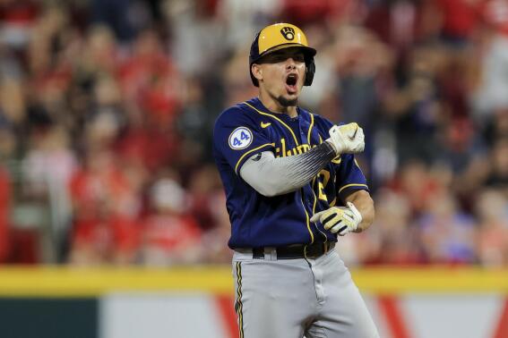 Milwaukee Brewers' Willy Adames yells at second base after hitting an RBI single during the seventh inning of the team's baseball game against the Cincinnati Reds in Cincinnati, Saturday, July 17, 2021. Willy Adames advanced to second base on the throw to home plate. (AP Photo/Aaron Doster)