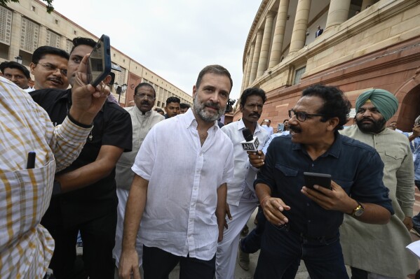 India's top opposition leader Rahul Gandhi, center, arrives at the Parliament in New Delhi, India, Monday, Aug.7, 2023. India's Parliament on Monday reinstated Gandhi as a lawmaker three days after the country's top court halted his criminal defamation conviction for mocking the prime minister's surname. (AP Photo)