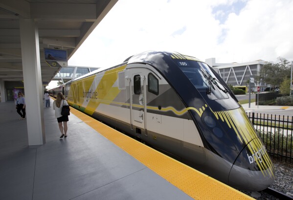 FILE - A Brightline train is shown at a station in Fort Lauderdale, Fla., on Jan. 11, 2018. A high-speed rail line between Las Vegas and the Los Angeles area is getting a Biden administration pledge of $3 billion to help start laying track. Nevada's two Democratic U.S. senators said Tuesday, Dec. 5, 2023 the $12 billion project led by Brightline West has all required right-of-way, environmental and labor approvals. (AP Photo/Wilfredo Lee, File)