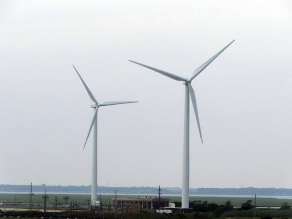 Land-based wind turbines in Atlantic City, N.J., turn on July 20, 2023. On Aug. 30, the offshore wind energy company Orsted said it is delaying its first offshore wind project in New Jersey until some time in 2026; it had previously been due to be completed by 2024. (AP Photo/Wayne Parry)