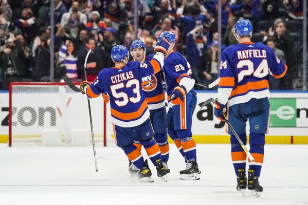 New York Islanders players celebrate after a goal scored by teammate Brock Nelson against the Colorado Avalanche during the third period of an NHL hockey game, Saturday, Oct. 29, 2022, in Elmont, N.Y. (AP Photo/Eduardo Munoz Alvarez)