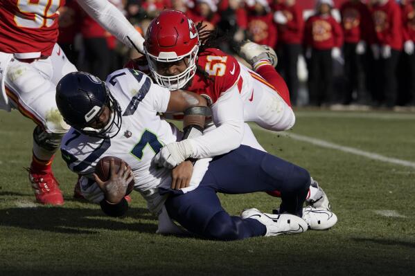 Seattle Seahawks quarterback Geno Smith (7) is sacked by Kansas City Chiefs defensive end Mike Danna (51) during the first half of an NFL football game Saturday, Dec. 24, 2022, in Kansas City, Mo. (AP Photo/Ed Zurga)
