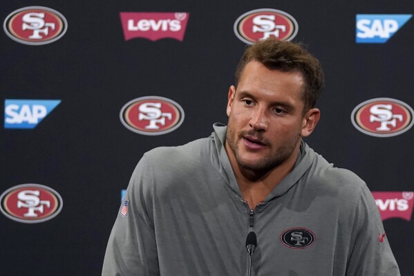 FILE - San Francisco 49ers' Nick Bosa speaks to reporters after NFL football practice in Santa Clara, Calif., Tuesday, June 6, 2023. Nick Bosa's lengthy contract holdout ended four days before the start of the season for the San Francisco 49ers when he agreed to a contract extension that will make him the NFL's richest defensive player ever. Coach Kyle Shanahan said Wednesday, Sept. 6, 2023, that the two sides agreed to the contract. (AP Photo/Jeff Chiu, File)