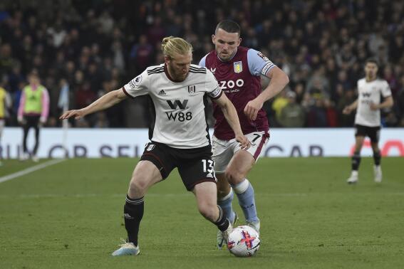 Aston Villa's John McGinn, right vies for the ball with Fulham's Tim Ream during the English Premier League soccer match between Aston Villa and Fulham at Villa Park in Birmingham, England, Tuesday, April 25, 2023. (AP Photo/Rui Vieira)