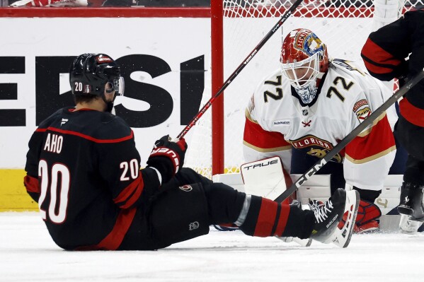 Carolina Hurricanes' Sebastian Aho (20) has his shot frozen by Florida Panthers goaltender Sergei Bobrovsky (72) during the third period of Game 1 of the NHL hockey Stanley Cup Eastern Conference finals in Raleigh, N.C., Tuesday, May 20, 2025. (AP Photo/Karl DeBlaker)
