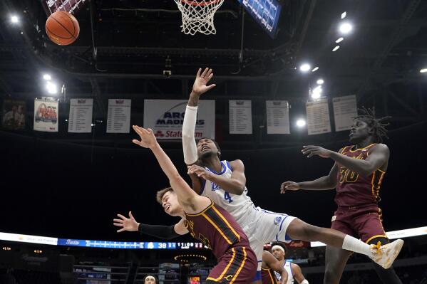 Drake's ShanQuan Hemphill, center, loses control of the ball as Loyola of Chicago's Braden Norris, left, and Aher Uguak (30) defend during the second half of an NCAA college basketball game in the championship of the Missouri Valley Conference tournament Sunday, March 6, 2022, in St. Louis. (AP Photo/Jeff Roberson)