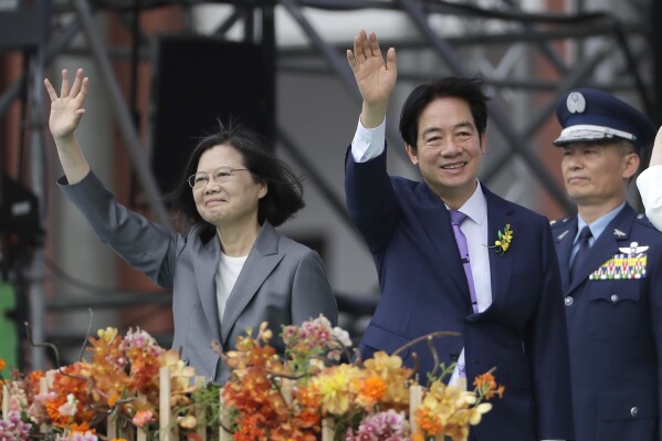 Taiwan's new President Lai Ching-te, right, and former President Tsai Ing-wen wave during Lai's inauguration ceremonies in Taipei, Taiwan, Monday, May 20, 2024. (AP Photo/Chiang Ying-ying)
