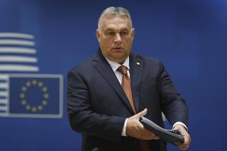 FILE - Hungary's Prime Minister Viktor Orban arrives to a round table meeting at an EU summit in Brussels, Friday, Oct. 22, 2021. The European Commission has launched proceedings that could ultimately lead to the partial suspension of support payments to Hungary for breaching the 27-nation bloc’s rule-of-law standards. The EU’s executive arm said Wednesday, April 27, 2022 that it has given Hungary formal notification and the country has two months to provide explanations and propose remedies. (John Thys, Pool Photo via AP, File)