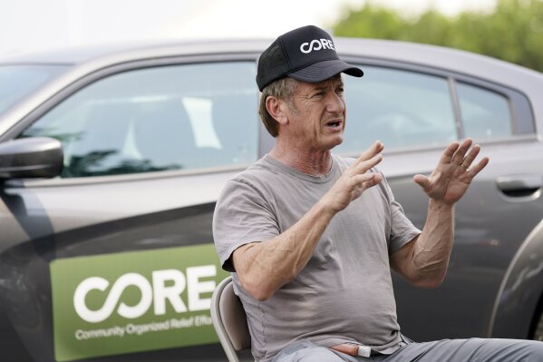 Actor Sean Penn, founder of Community Organized Relief Effort (CORE), is interviewed at a CORE coronavirus testing site at Crenshaw Christian Center, Friday, Aug. 21, 2020, in Los Angeles. Penn says his organization CORE has made some strides against the coronavirus and he's keeping its mission going by expanding testing and other relief services. (AP Photo/Chris Pizzello)