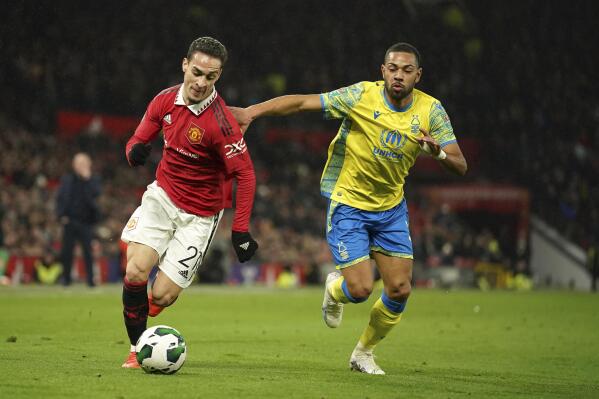 Nottingham Forest's Renan Lodi, right, chases Manchester United's Antony during the English League Cup semifinal second leg soccer match between Manchester United and Nottingham Forest at Old Trafford in Manchester, England, Wednesday, Feb. 1, 2023. (AP Photo/Dave Thompson)