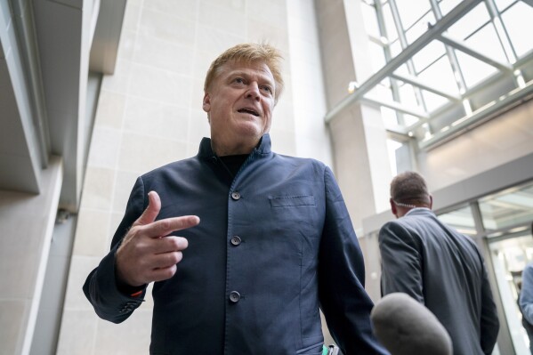 FILE - Patrick Byrne, the former chief executive of Overstock.com arrives at the O'Neill House Office Building on Capitol Hill in Washington, July 15, 2022. An attorney charged with illegally accessing Michigan voting machines after the 2020 election acknowledged in a court filing Monday, March 18, 2024, that she disseminated numerous confidential emails from a voting machine company in a separate case. Lambert had just joined the Dominion defamation case to represent Byrne. (AP Photo/J. Scott Applewhite, File)