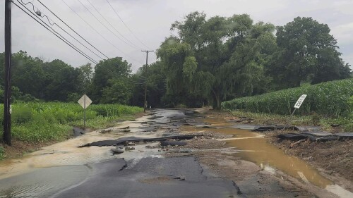 This photo provided by Jersey Central Power & Light shows flooding along Snyder Road, in Phillipsburg, N.J., near the intersection with county Route 519, Sunday, July 16, 2023. (Courtesy of JCP&L via AP)