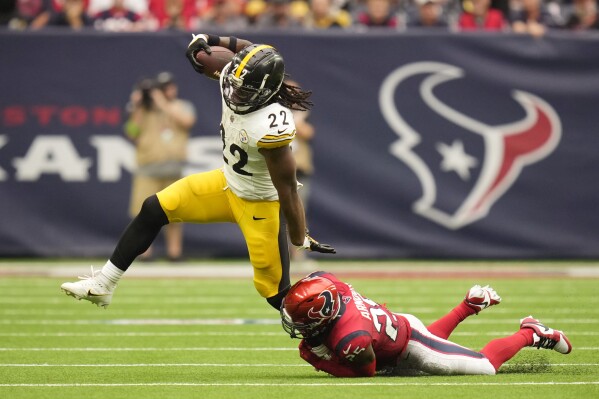 Pittsburgh Steelers running back Najee Harris (22) is grabbed by Houston Texans safety Grayland Arnold (25) during the second half of an NFL football game Sunday, Oct. 1, 2023, in Houston. (AP Photo/Eric Christian Smith)