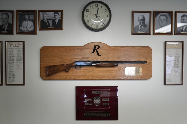 A shotgun made by Remington Arms, gifted by the company to the town, hangs on the wall of the municipal building in Ilion, N.Y., Thursday, Feb. 1, 2024. The nation鈥檚 oldest gun-maker is consolidating operations in Georgia and recently announced plans to shutter the Ilion factory in early March. (APPhoto/Seth Wenig)
