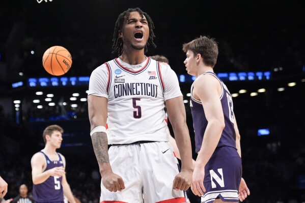 UConn guard Stephon Castle (5) reacts after scoring during the first half of a second-round college basketball game against Northwestern in the NCAA Tournament, Sunday, March 24, 2024, in New York. (AP Photo/Mary Altaffer)