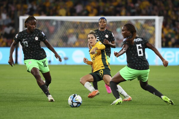 Australia's Katrina Gorry, center, plays the ball next to Nigeria's Ifeoma Onumonu, right, and Christy Ucheibe, left, during the Women's World Cup Group B soccer match between Australia and Nigeria In Brisbane, Australia, Thursday, July 27, 2023. Nigeria won 3-2. (AP Photo/Tertius Pickard)