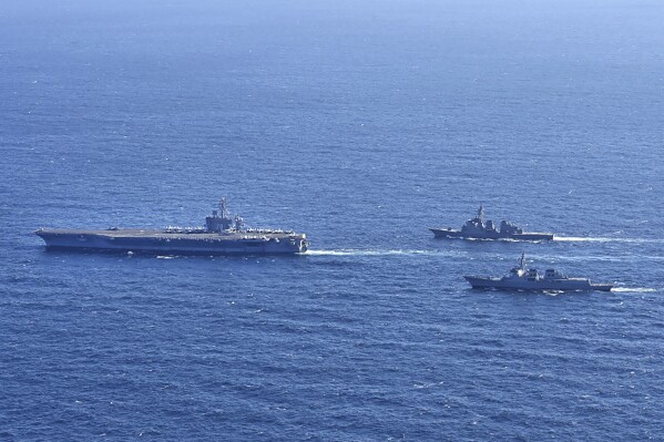 In this photo provided by South Korea's Joint Chiefs of Staff, the aircraft carrier USS Carl Vinson, left, sails with South Korean Navy's Aegis destroyer King Sejong the Great and Japan's Maritime Self-Defense Force Aegis destroyer Kongou in the international waters of the southern coast of Korean peninsular during a recent joint drill in 2024. The three countries conducted combined naval exercises involving the American aircraft carrier in their latest show of strength against nuclear-armed North Korea, South Korea’s military said Wednesday, Jan. 17, as the three countries' senior diplomats were to meet in Seoul to discuss the deepening standoff with Pyongyang. (South Korea's Joint Chiefs of Staff via AP)
