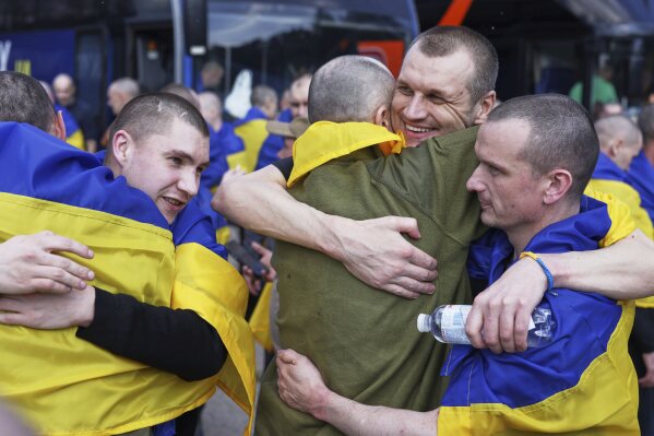 Ukrainian soldiers hug each other after returning from captivity following an exchange between Russia and Ukraine, in Chernyhiv region, Ukraine, Friday, May 23, 2025. (AP Photo)