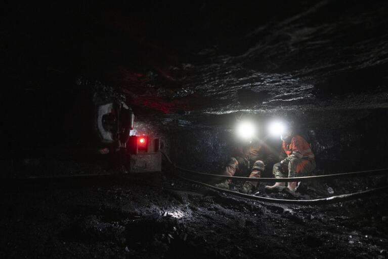 Coal miners work at the bottom of the Gruve 7 coal mine in Adventdalen, Norway, Monday, Jan. 9, 2023. Gruve 7, the last Norwegian mine in one of the fastest warming places on earth, was scheduled to shut down this year and only got a reprieve through 2025 because of the energy crisis driven by the war in Ukraine. (AP Photo/Daniel Cole)