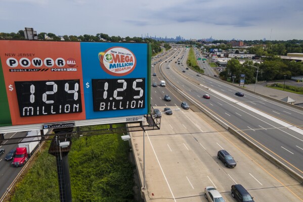 A billboard over Interstate 80 displays a Mega Millions lottery jackpot of $1.25 billion, Thursday, Aug. 3, 2023, in Lodi, N.J. The odds of winning a $1.25 billion Mega Millions jackpot Friday night are infinitesimally small, but that doesn't stop players from some mighty big daydreams of what they would do if they won the giant prize. (AP Photo/Ted Shaffrey)